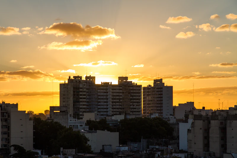 city skyline under cloudy sky during sunset