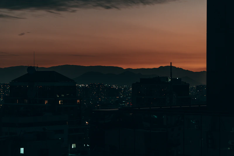 City skyline at dusk with mountains in background