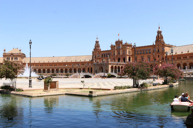 Grand building with fountain and boats on water