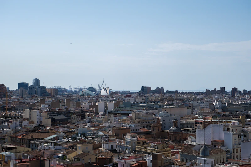 An expansive cityscape under a bright blue sky.